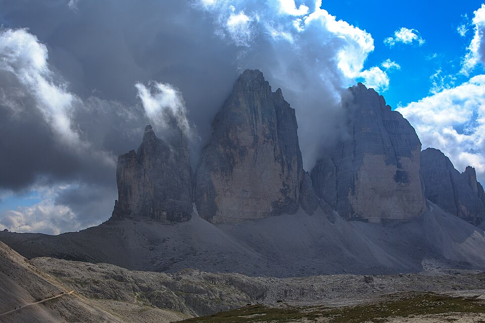 Tre Cime bajo nubes cambiantes vistas desde un sendero