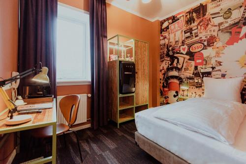 Dormitorio con cama y escritorio con televisión en Hotel Hafnia